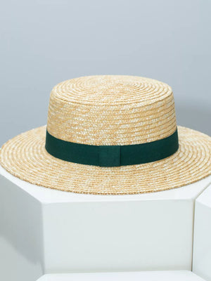 Women's straw boater hat with dark green ribbon band