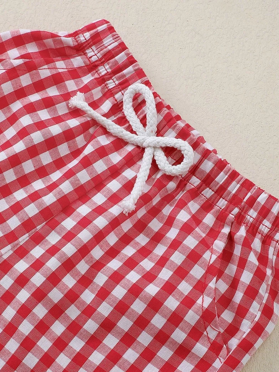 Baby shorts with red and white gingham pattern and drawstring waist.