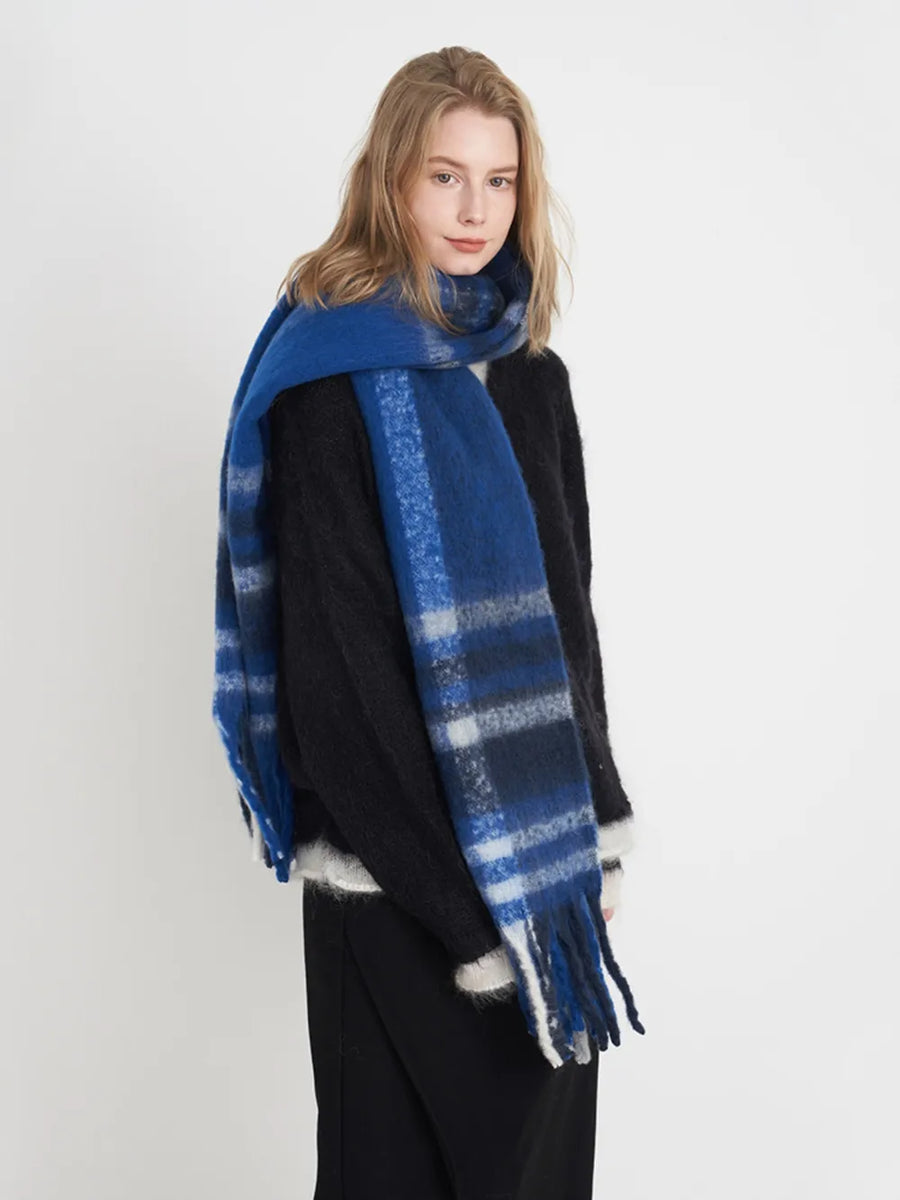 Textured plaid fringe wrap scarf in blue/white/gray plaid with soft fringe detail.