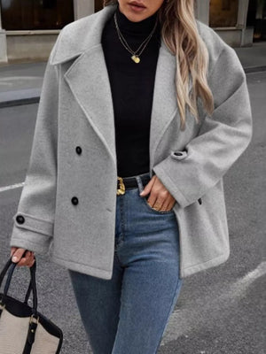 Light gray double-breasted wool blend pea coat with black buttons and lapel collar.