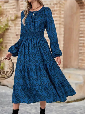 Blue abstract pattern midi dress with smocked waist, balloon sleeves and tiered skirt.