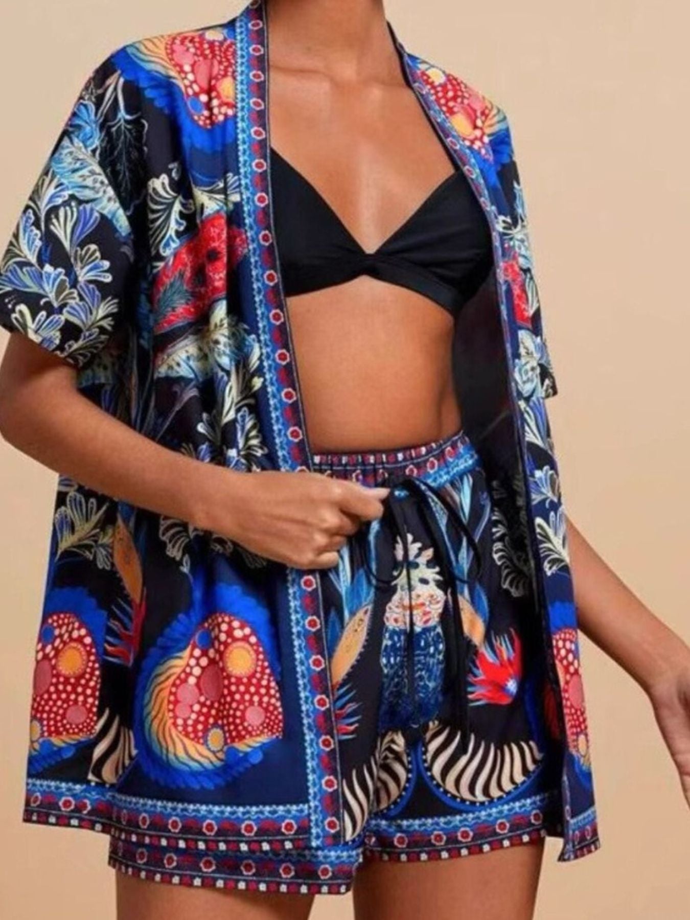 Navy tropical print cardigan and drawstring shorts ensemble with short sleeves and a relaxed fit.