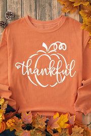 Corduroy sweatshirt in sherbet orange with a white pumpkin graphic and the word thankful.