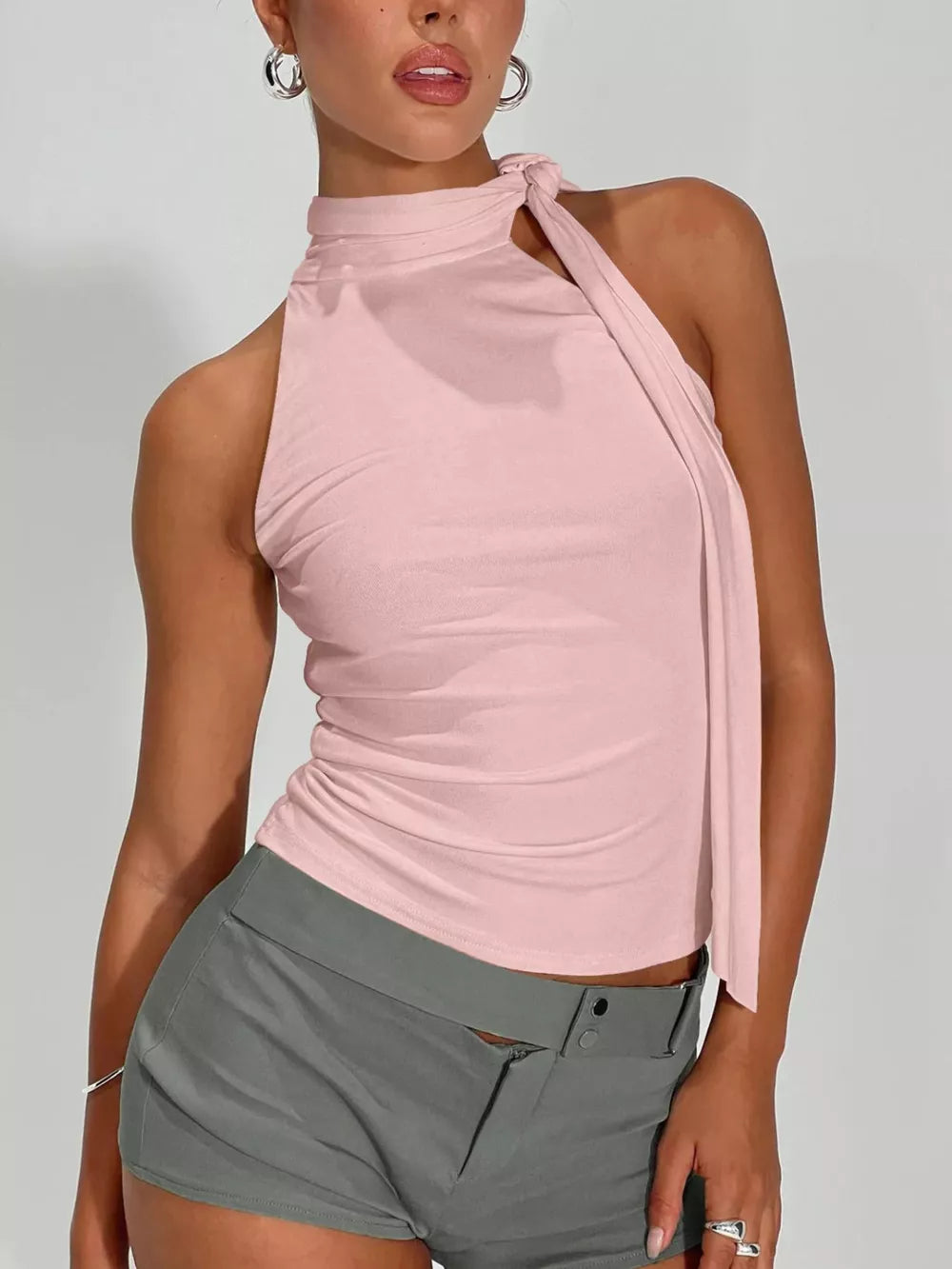 Pink halter neck sleeveless top with tie detail and ruched sides