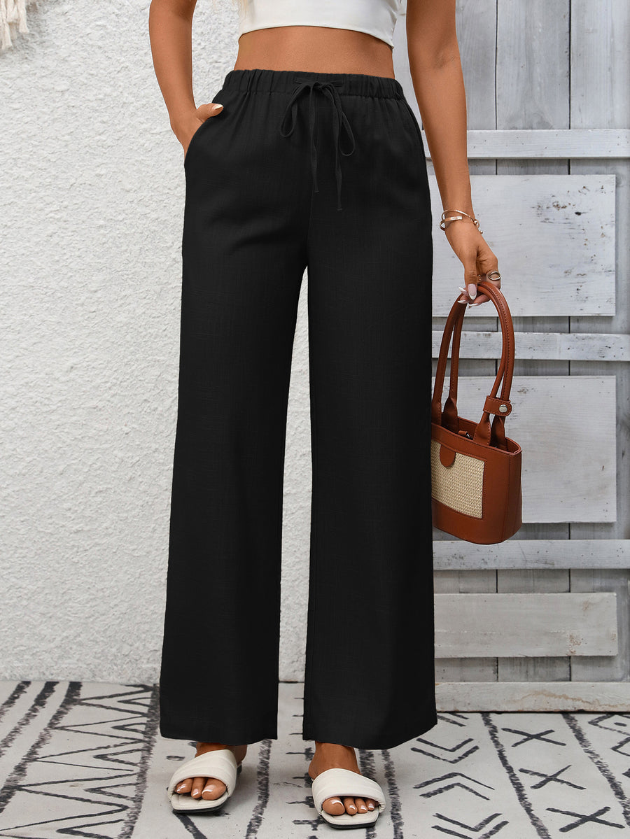 Black high-waist wide-leg pants with drawstring and pockets.
