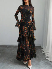 Black floral mermaid maxi dress with sheer flounce sleeves and tiered skirt.