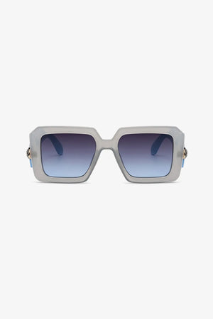 Geometric facet sunglasses in pastel blue with gradient lenses and gold embellishment detail.
