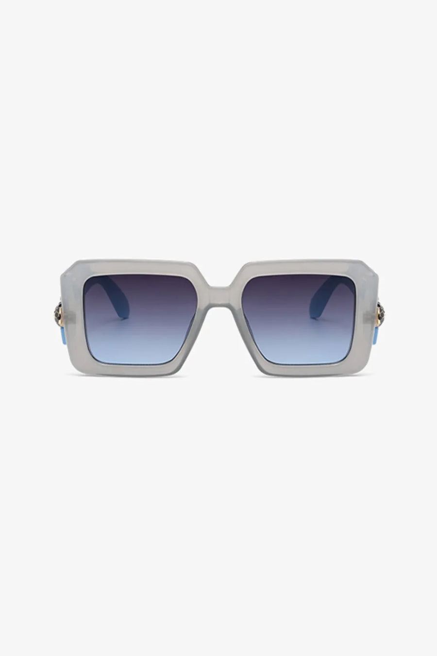 Geometric facet sunglasses in pastel blue with gradient lenses and gold embellishment detail.