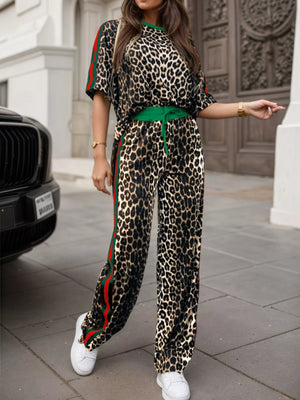 Leopard print loungewear set with green trim and side stripes, featuring a crew neck top and wide-leg pants.