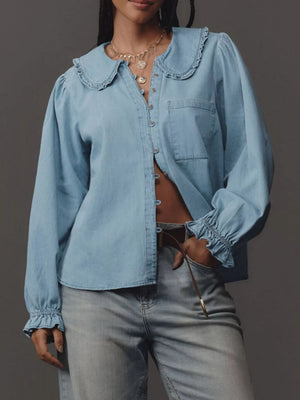 Blue denim shirt with ruffled Peter Pan collar, button front, and ruffled cuffs.