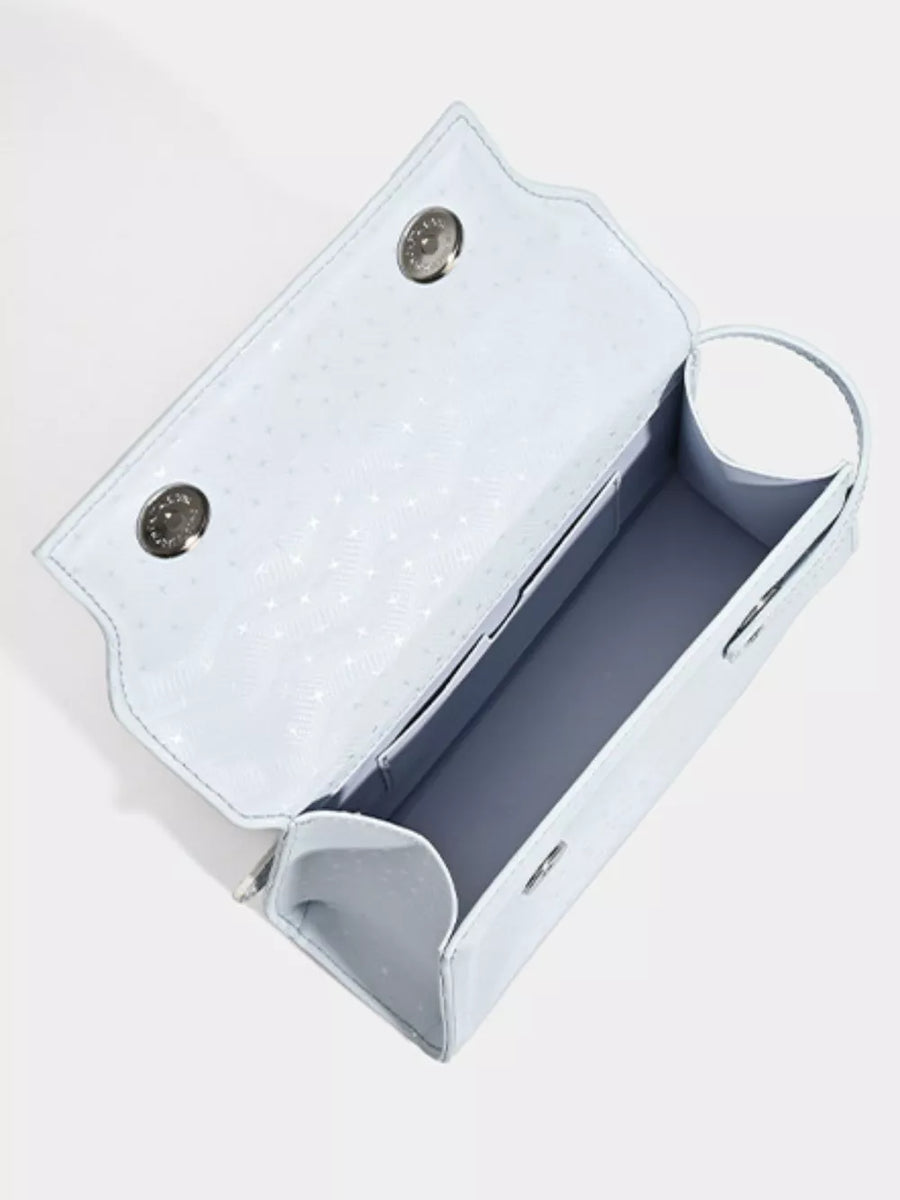 Chic mini pu leather tote in blue with buckle detail and patterned interior.