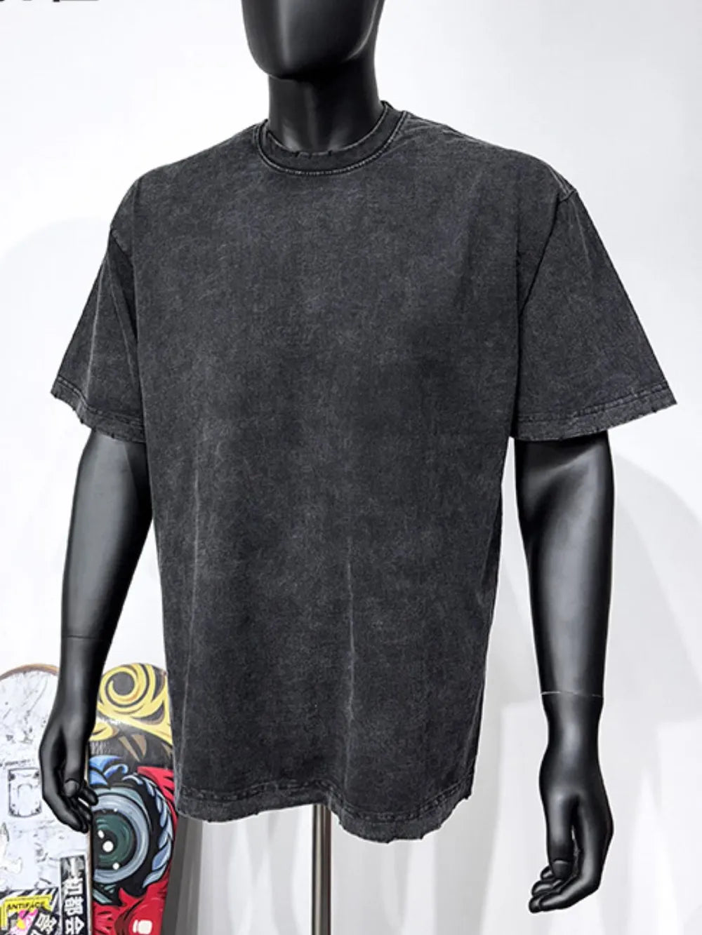 Black acid wash oversized tee with distressed neckline and hem.