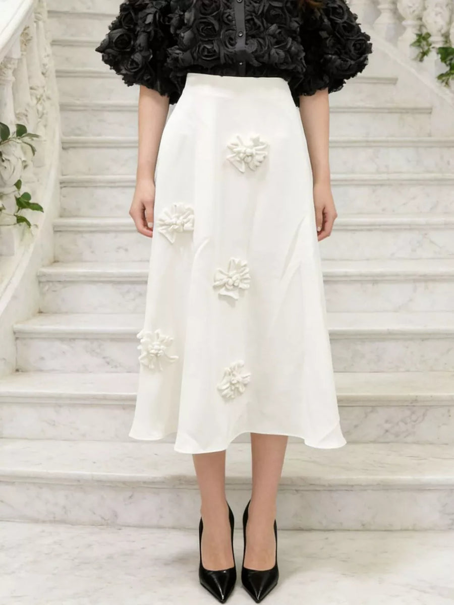 White midi skirt with floral applique and a-line cut.