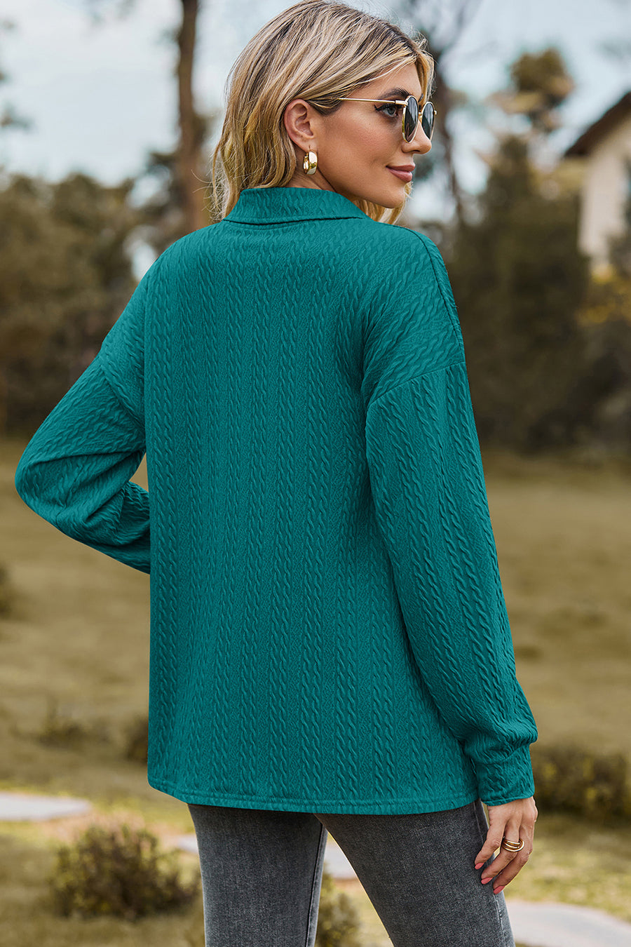Teal textured polo-neck sweater with button detail and long sleeves.