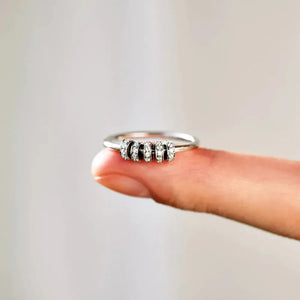 Sterling silver ring with five movable bands, each encrusted with pavé set cubic zirconia stones.