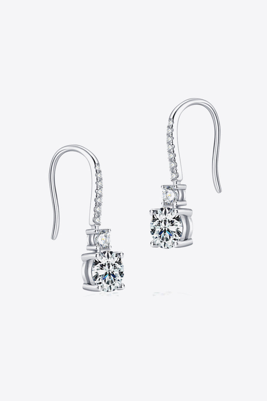Silver moissanite drop earrings with a cascade of sparkling stones and a large center stone.