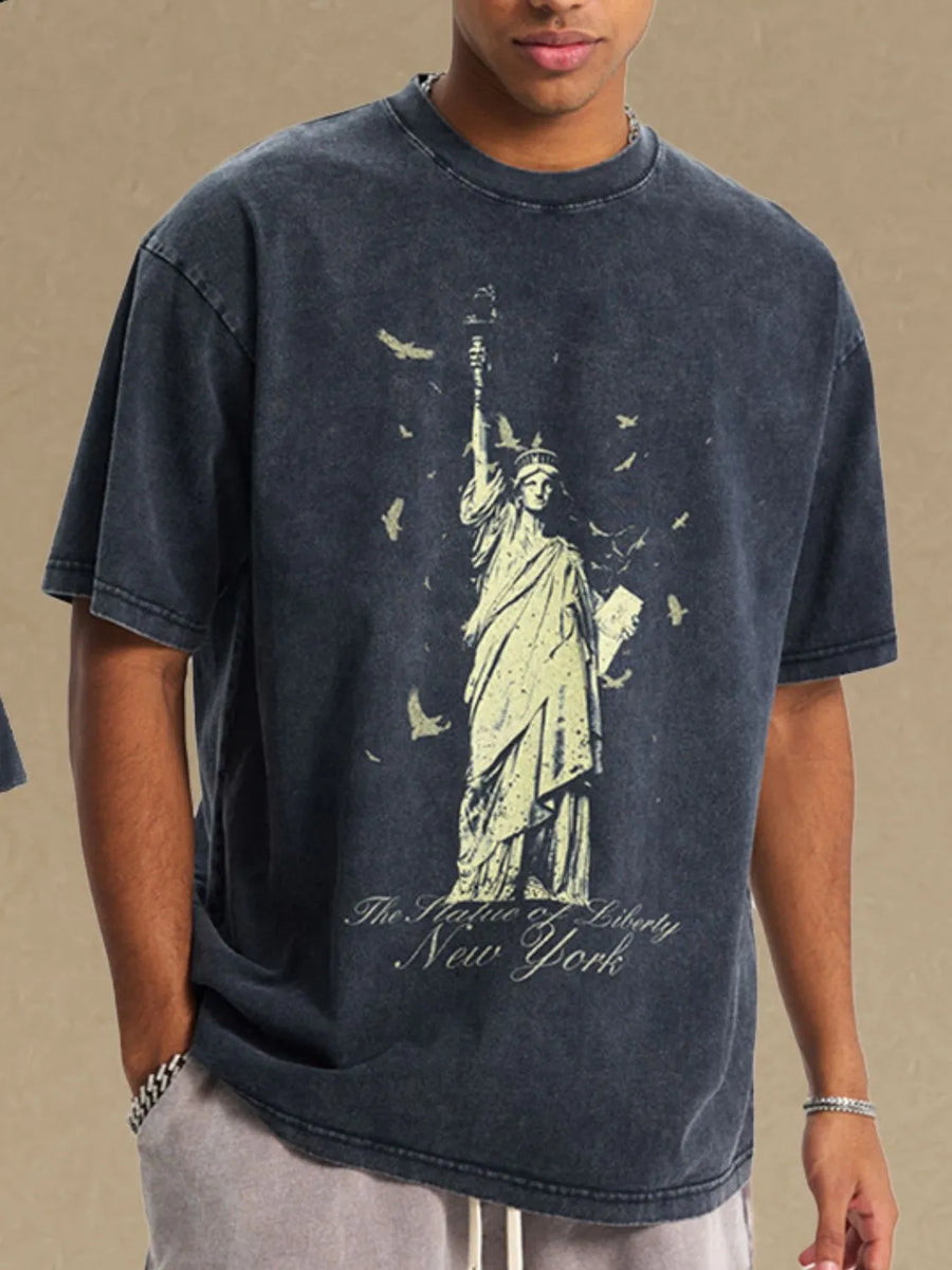 Black vintage wash t-shirt with Statue of Liberty graphic and birds.