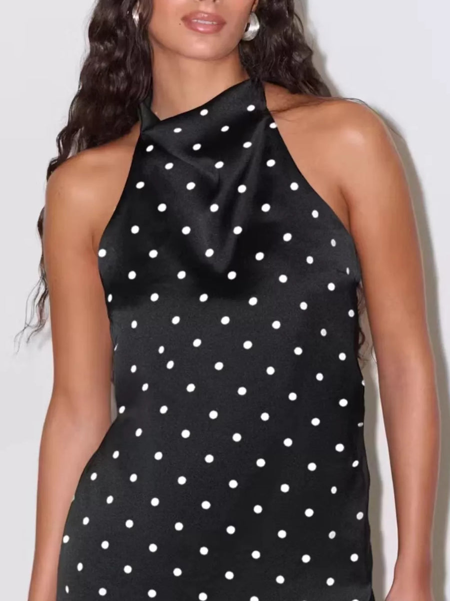 Black satin halter neck top with white polka dots and a draped neckline.