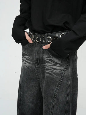Faded panel wide-leg jeans in dark wash denim with a distressed pattern and a grommet belt.