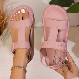 Dusty pink T-strap buckle platform sandals with adjustable ankle strap.