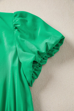 Green maxi dress with ruched puff sleeves and elasticated cuffs.