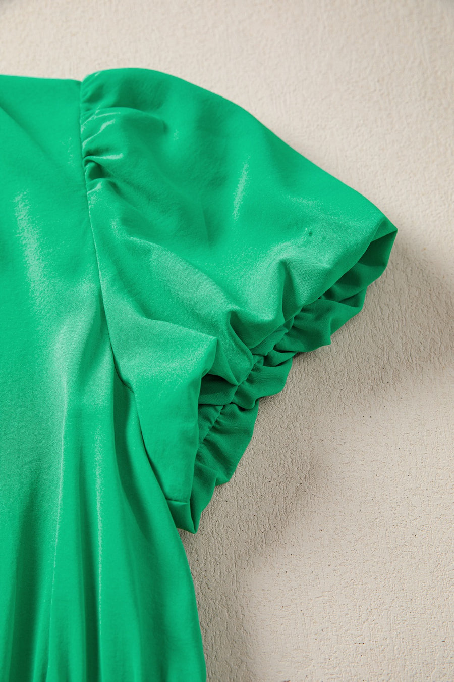 Green maxi dress with ruched puff sleeves and elasticated cuffs.