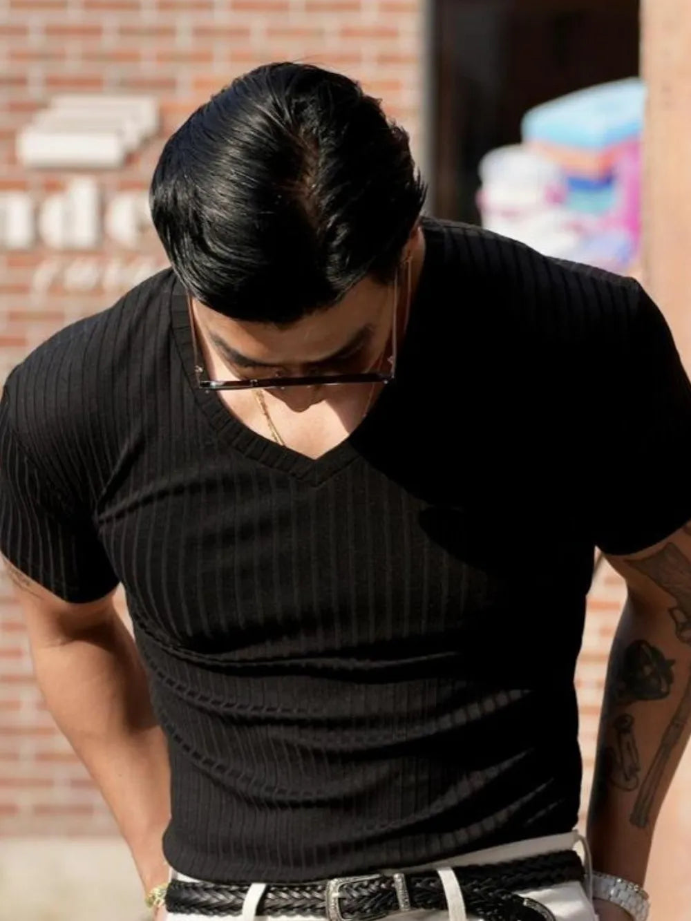 Black ribbed slim-fit V-neck t-shirt with short sleeves.