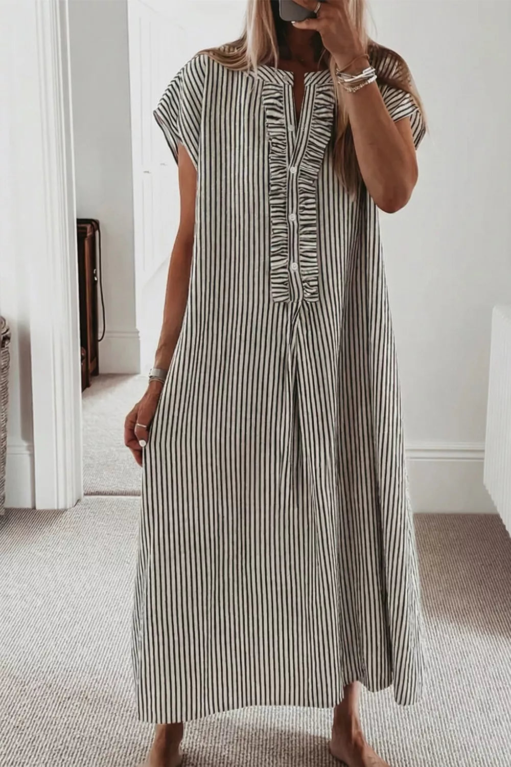 Black and white striped maxi dress with ruffle neckline and cap sleeves.