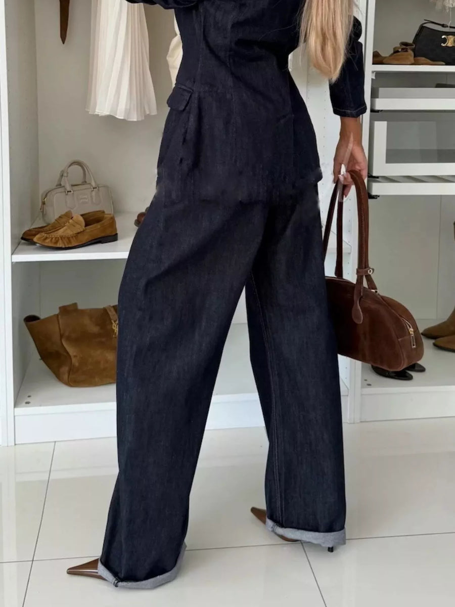 Dark navy high-waisted wide-leg jeans with cuffed hems.