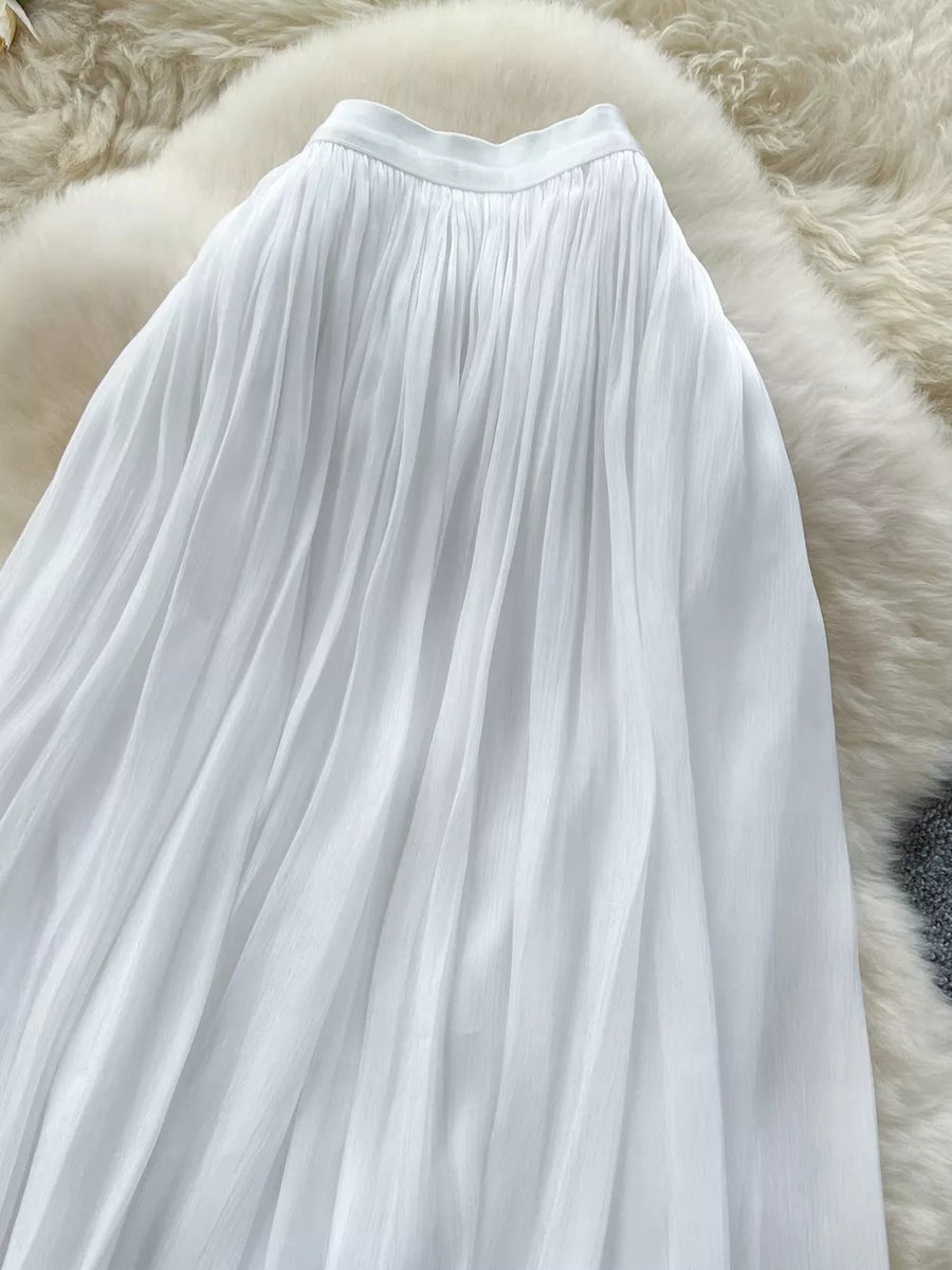 White pleated maxi skirt with a flowy, elegant cut.