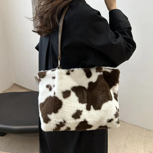 Cowhide print faux fur shopper bag with brown and white pattern.