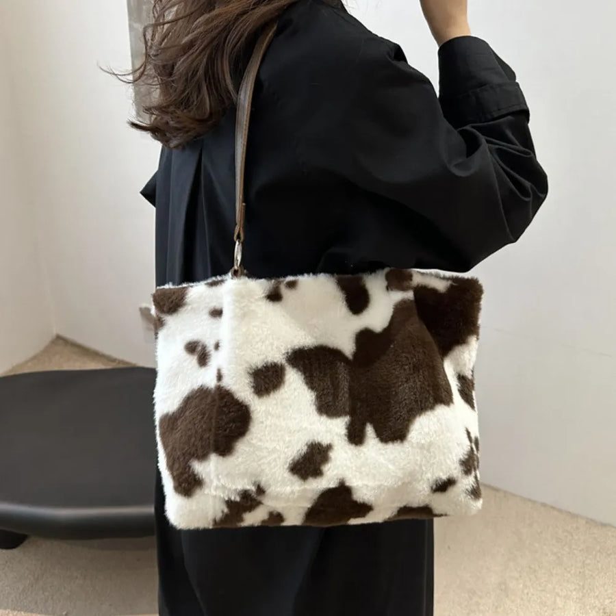 Cowhide print faux fur shopper bag with brown and white pattern.