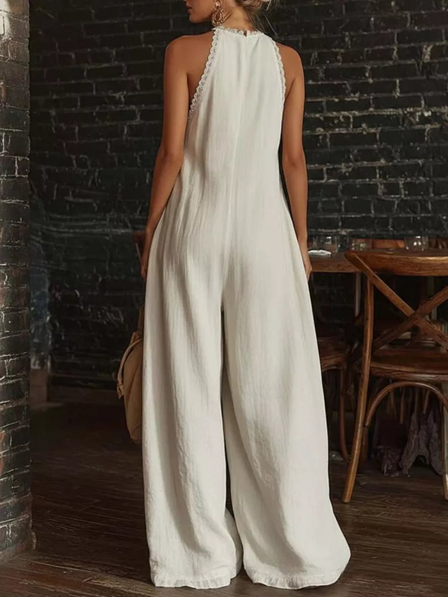 White linen halter jumpsuit with wide legs and lace trim detail