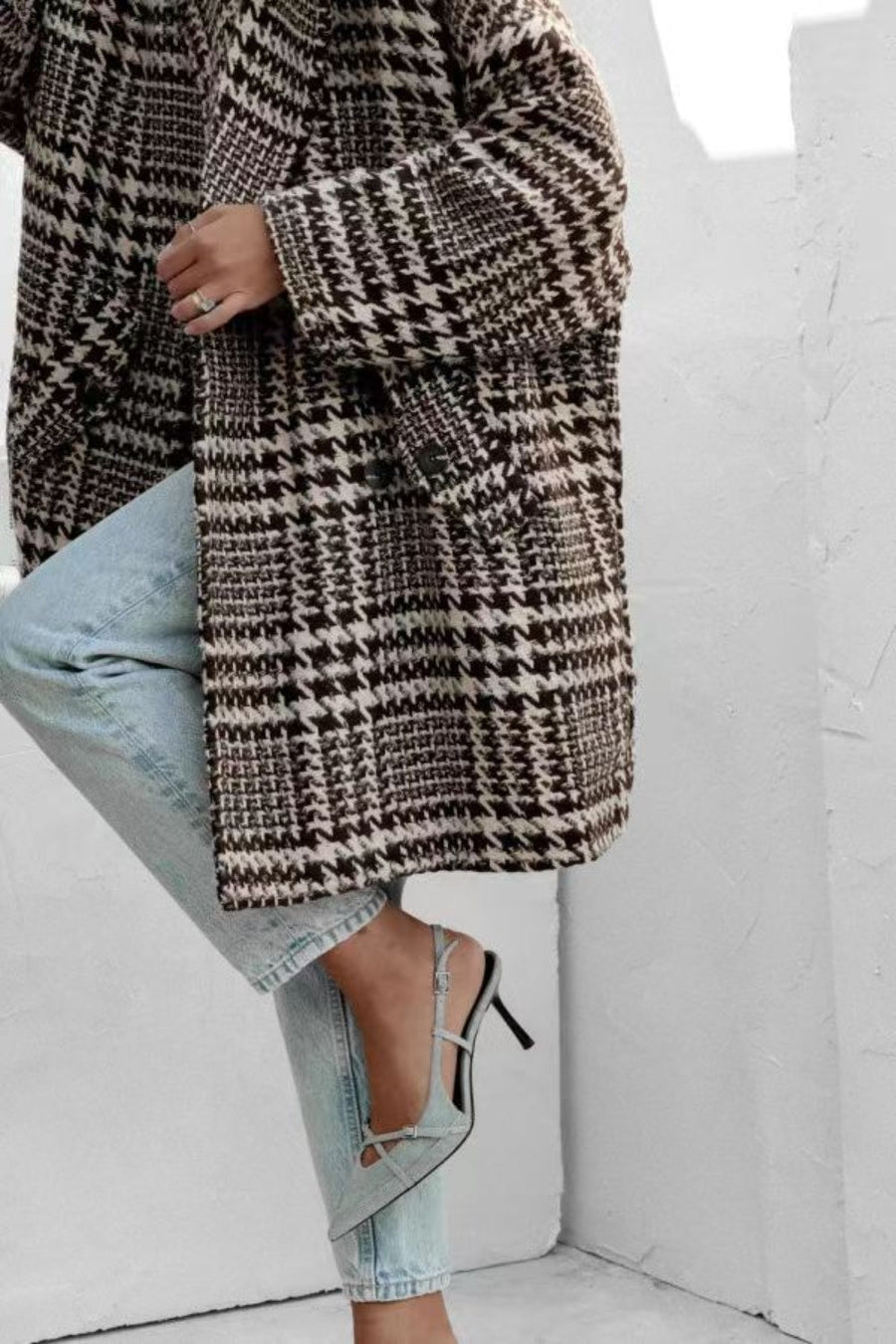 Oversized houndstooth cocoon coat in black and brown with button closure.