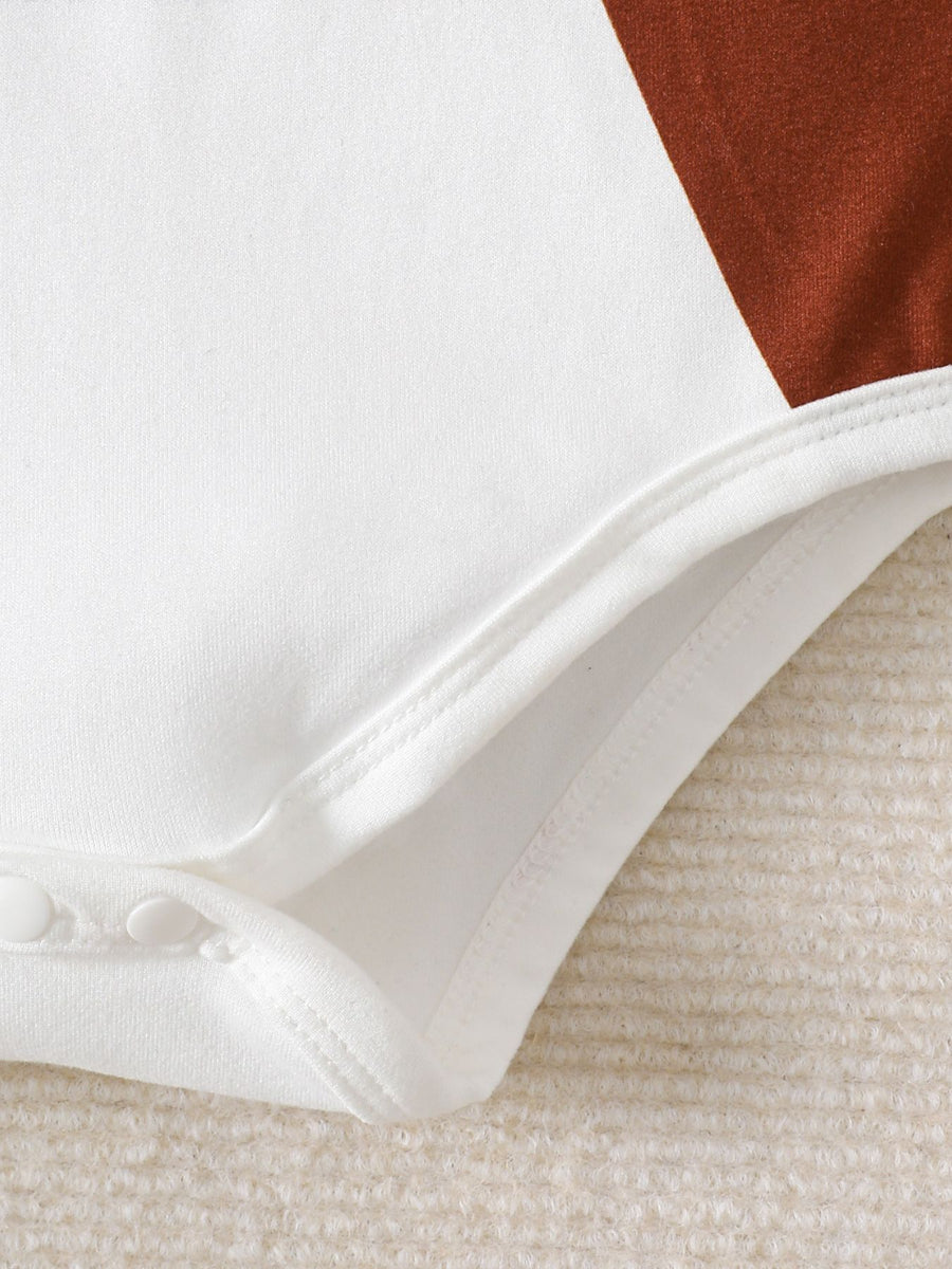 White baby bodysuit with brown color block detail and snap closure