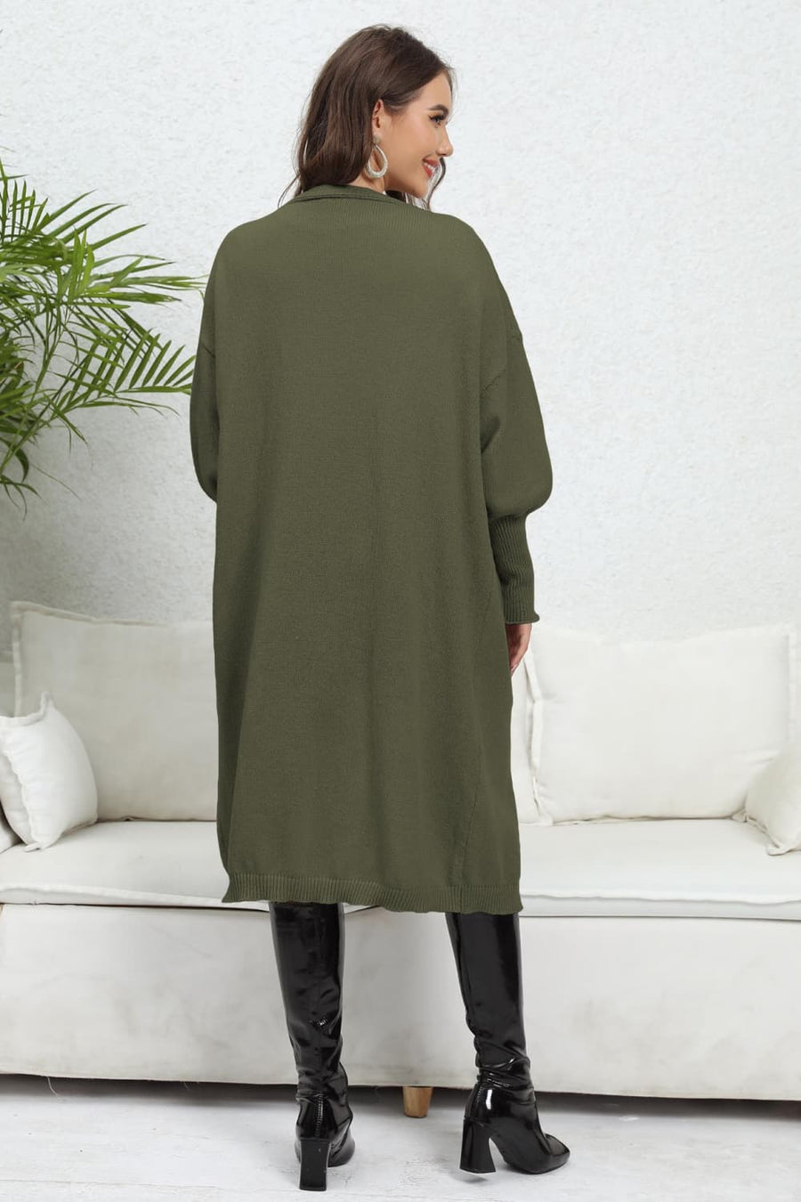 Army green oversized knit cardigan with pockets, long sleeves, and a relaxed fit.