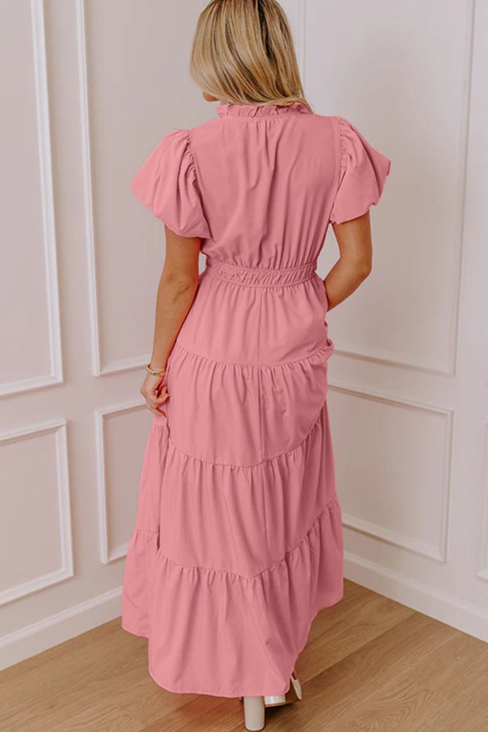 Dusty pink maxi dress with puff sleeves, ruffled neckline, and tiered skirt.