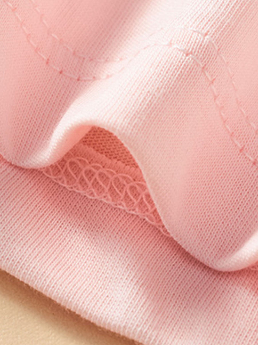 Blush pink cotton t-shirt detail showing crew neck stitching and soft fabric.