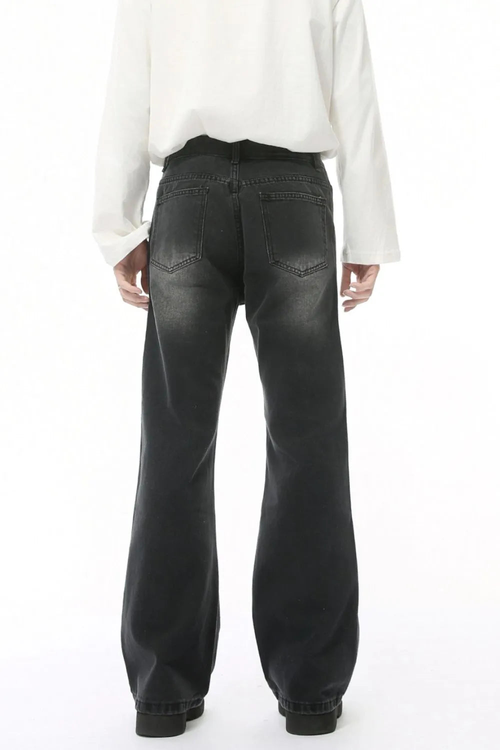 Dark wash wide leg jeans with back pockets and a faded look.