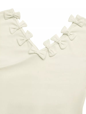 Ribbed knit V-neck t-shirt in cream with decorative bow details along the neckline.