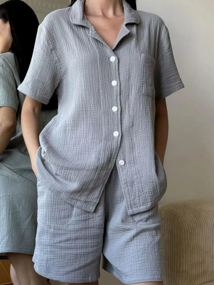 Gray cotton button-up pajama set with collared shirt and shorts.