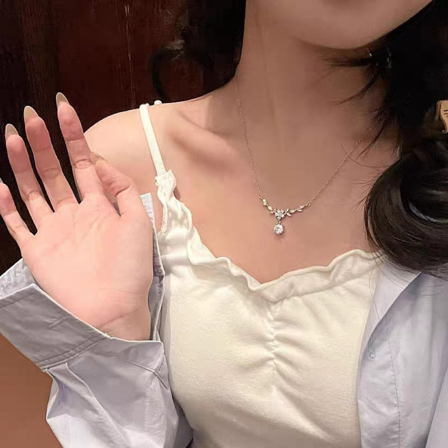 necklace in clear with floral and leaf motif