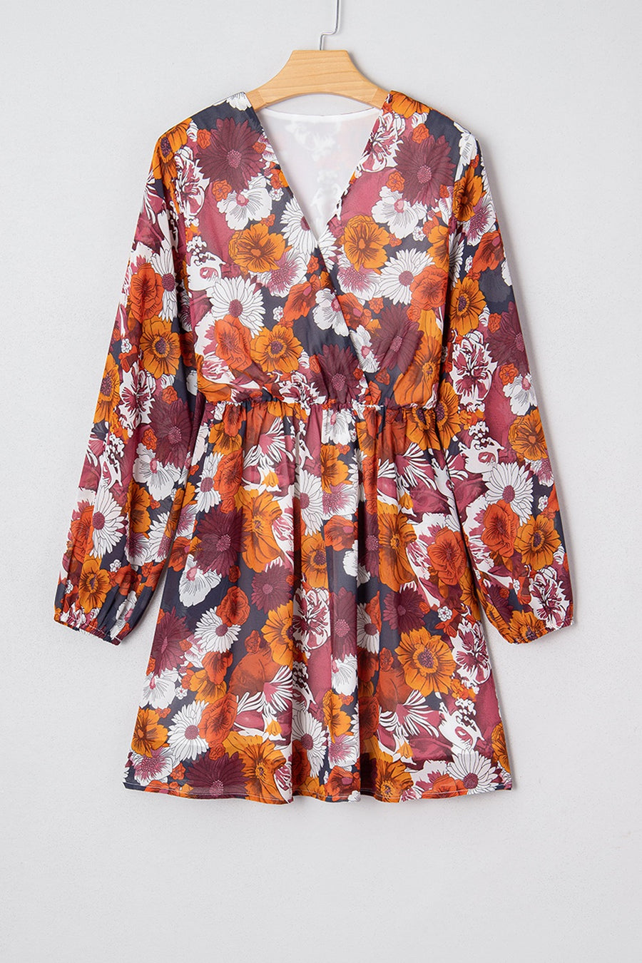 Floral wrap mini dress with puff sleeves and a V-neck in autumnal colors.