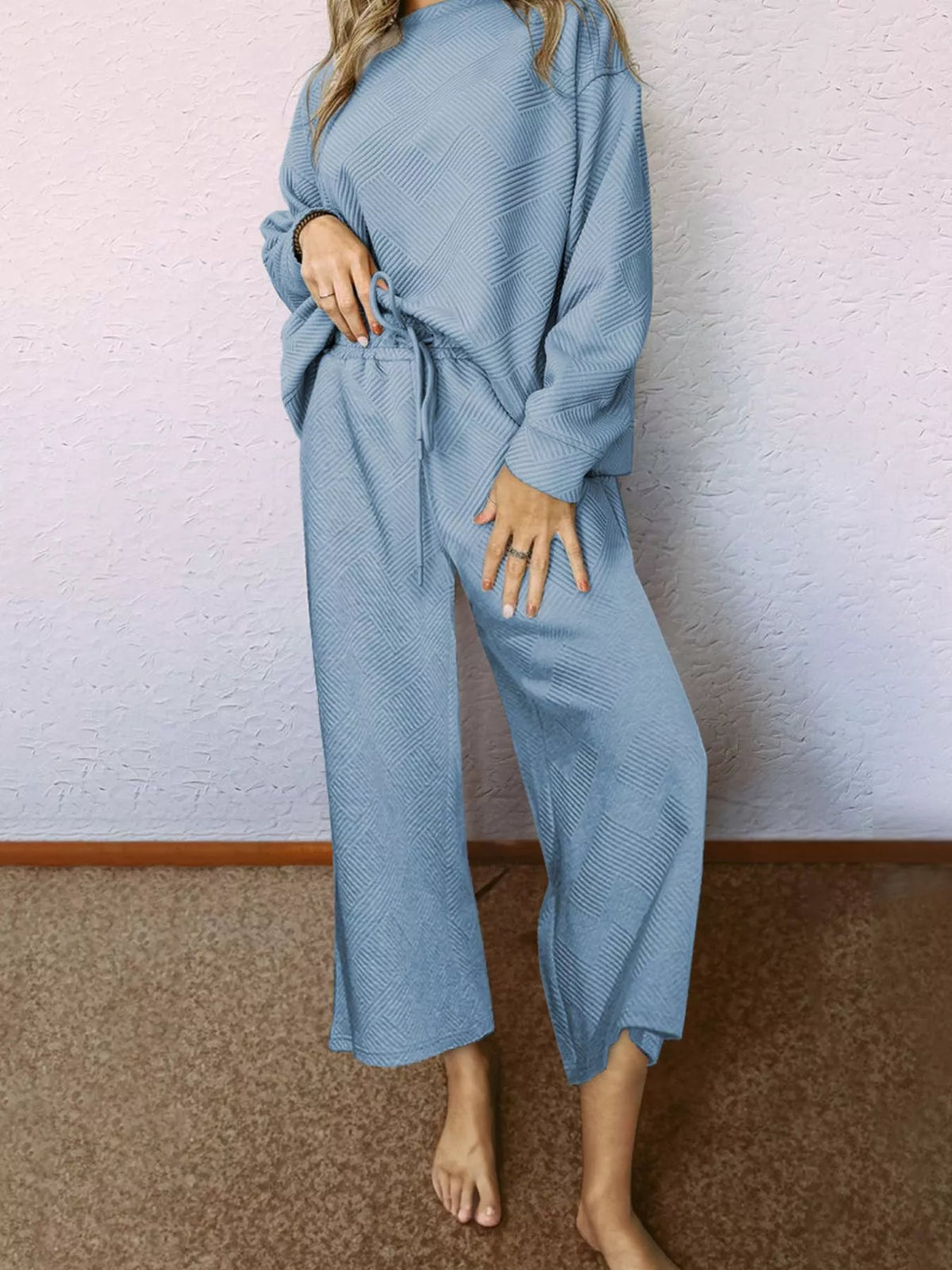Light blue textured drawstring two-piece set with wide leg pants and crew neck top