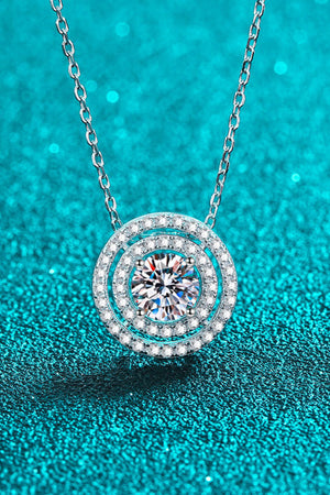 Silver halo diamond pendant necklace with a central sparkling stone.