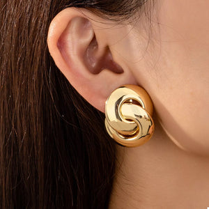 Chunky knot gold-plated earrings with interlocking loops.