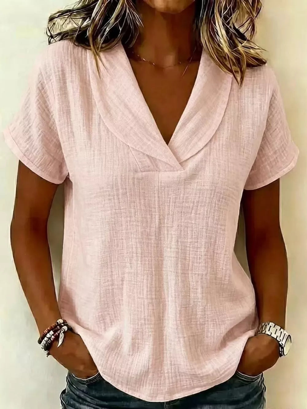 Lotus color textured blouse with V-neck and short sleeves, styled casually.