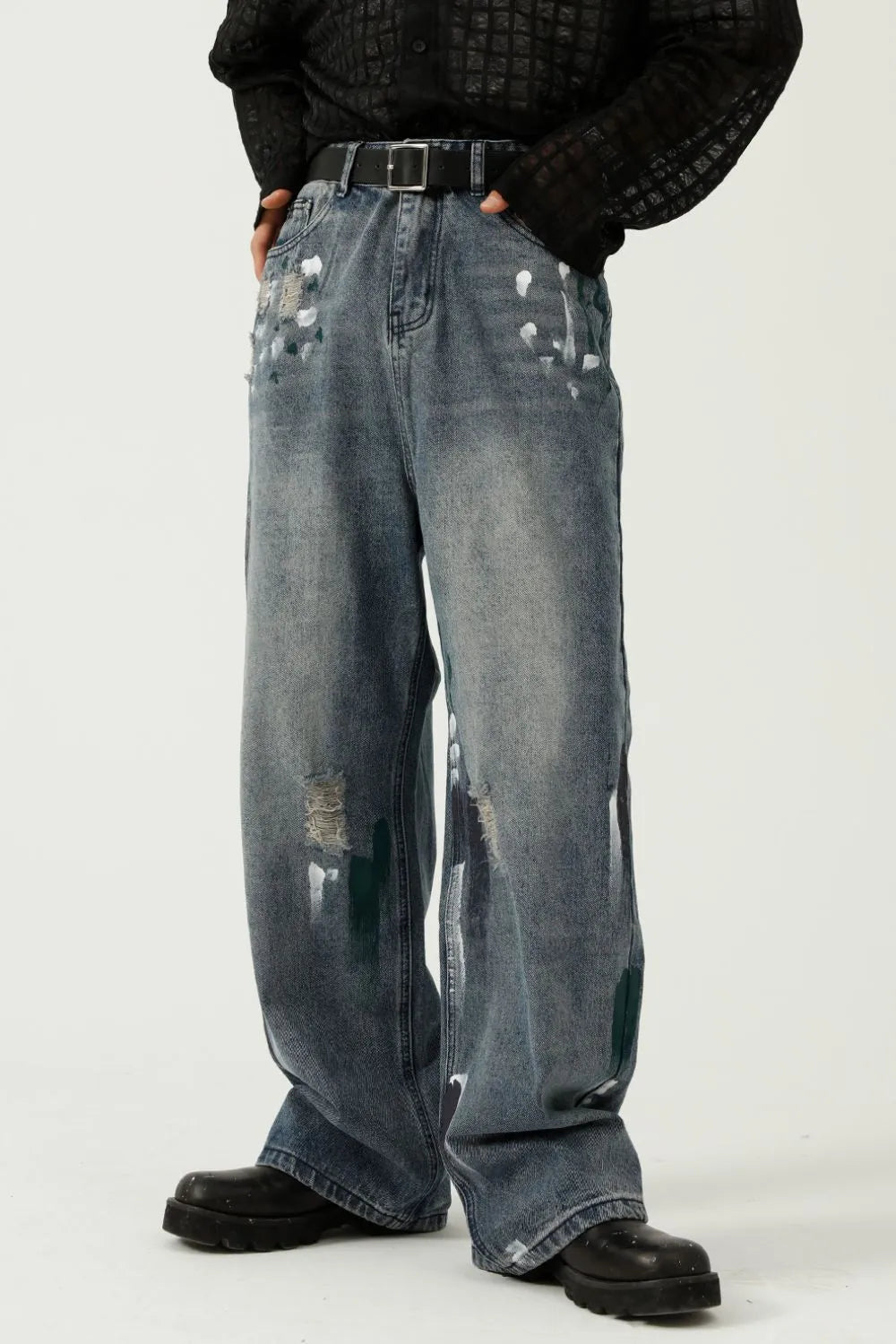 Medium wash baggy jeans with paint splatter details and distressed rips.