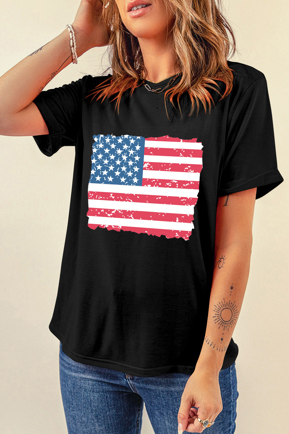 Black cotton t-shirt with a distressed American flag graphic and torn edges.
