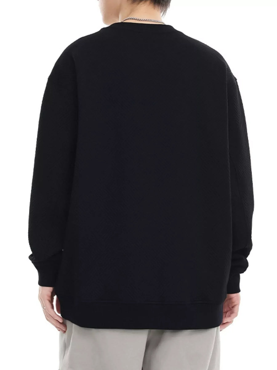 Black crew neck sweatshirt with textured fabric and ribbed cuffs and hem.
